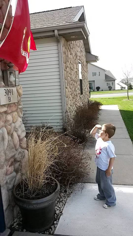 Saluting the Marine Corps flag
