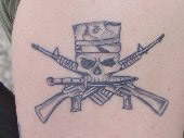Skull and Crossed Guns Tattoo
